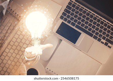 Bulb drawing over computer on the desktop background. Top view. Double exposure. Idea concept.