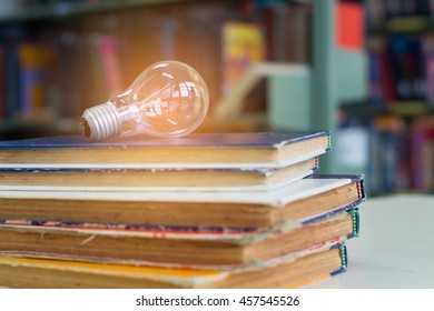 Bulb on books in library