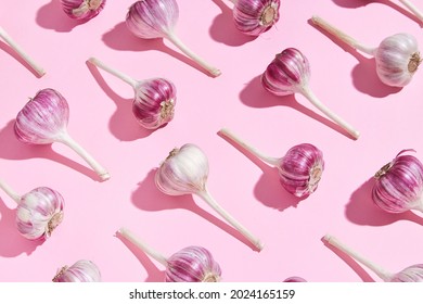 Bulbs of garlic on a colored background, colorful garlic  pattern. Garlic on cyan mint blue  background - Shutterstock ID 2024165159