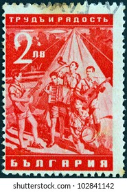 BULGARIA - CIRCA 1942: A stamp printed in Bulgaria from the "Work and Joy" issue shows boys playing music in camp, circa 1942.