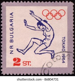 BULGARIA - CIRCA 1964: A Post Stamp Printed In Bulgaria Shows Broad Jump, Devoted To Olympic Games In Tokio, Series, Circa 1964