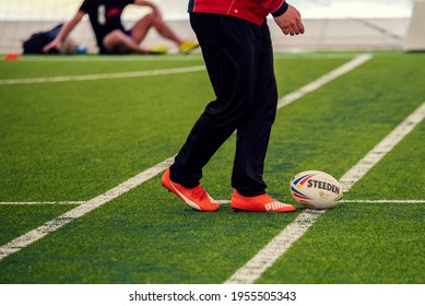 Bulgaria, Sofia, FEB 20, 2021:Ball For Australian Football Called Touch Footy On A Playground Field And Human Body Part Before Start The Game