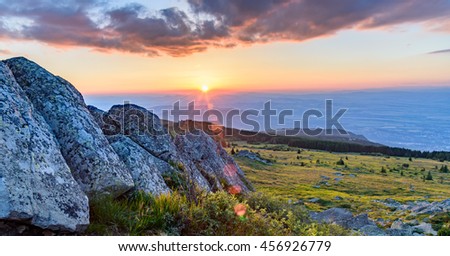 Bulgaria, Vitosha, Black Peak - amazing sunset shot from the top of the mountain - beautiful landscape with green grass and impressive rocks - last rays of sunlight
