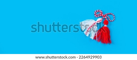 Bulgarian symbol of spring, many white and red martenitsa on blue banner background