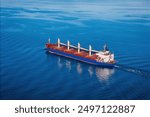 Bulk cargo carrier ship underway in calm sea. Dry cargo vessel merchant ship to transport bulk cargo such as grains ore coal