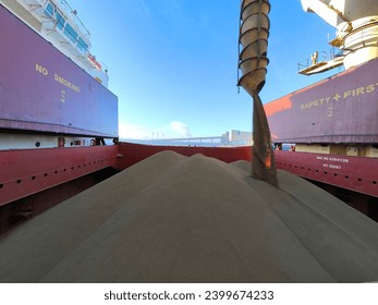 Bulk cargo loading into hold of a ship or vessel