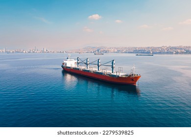 Bulk carrier or bulker anchored nearby port waiting uploading, Aerial wide shot