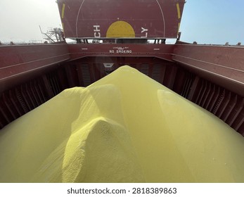 The bulk carrier is engaged in loading sulfur cargo for export through maritime transportation.