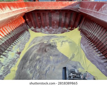 The bulk carrier is engaged in loading sulfur cargo for export through maritime transportation.