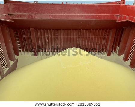 The bulk carrier is engaged in loading sulfur cargo for export through maritime transportation.