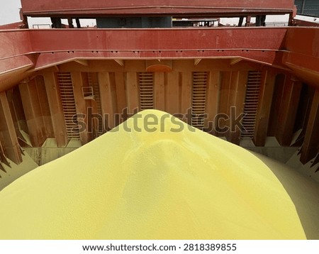 The bulk carrier is engaged in loading sulfur cargo for export through maritime transportation.