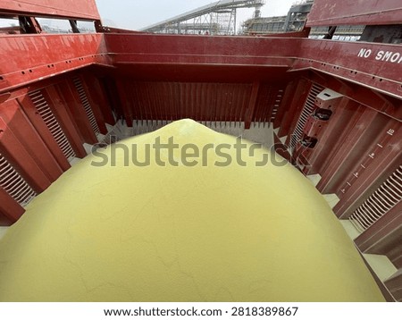 The bulk carrier is engaged in loading sulfur cargo for export through maritime transportation.