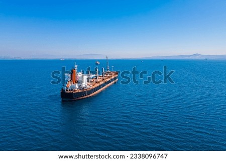 Bulk carrier ship anchored in Aegean sea waiting entering port, Aerial view