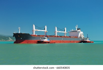 Bulk Carrier Ship Escorted By Two Tugboat Enters The Port