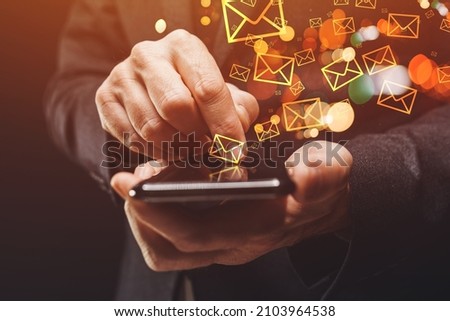Bulk messaging, businessman sending large amount of SMS messages on smartphone, closeup of hands with selective focus