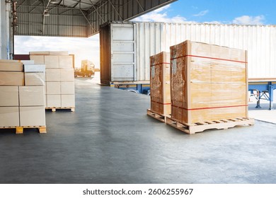 Bulk of Package Boxes Waiting to be Loaded into Containers Trucks. Distribution Shipping Cargo Container. Semi Trailer Trucks on The Parking Lot at Sunset. Freight Truck Logistics Transportation.	
