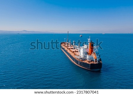 Bulk vessel for dry cargo in anchorage in sea waiting loading in industrial port, established shot