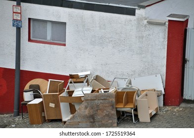 bulky Household furniture trash piled up at roadside