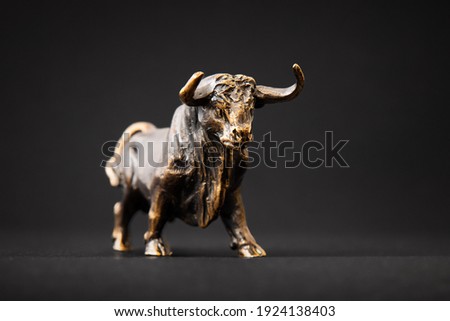 Bull figurine isolated on black background