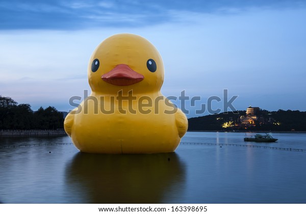 The bull and the rhubarb (yellow) duck in Summer\
Palace of Beijing, China.