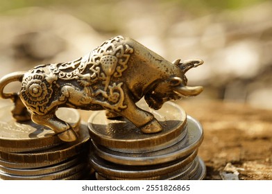 A bull statuette with coins. Finance and economics. - Powered by Shutterstock