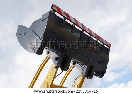 A bulldozer arm (or push frame) with a bulldozer blade, representing heavy machinery for construction, paving, mining, and other purposes.