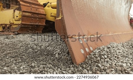 bulldozer with blade in the gravel