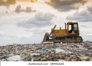 Bulldozer compactor working in landfill of waste