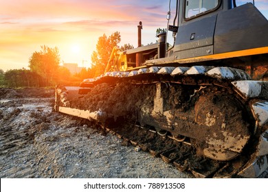 bulldozer at construction site and sunrise landscape