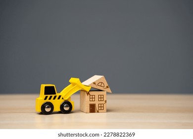 The bulldozer demolishes the house. Encroachment on private property. Illegal buildings and construction. Violation of building codes. Housing renovation. Renovation of an old real estate fund. - Shutterstock ID 2278822369