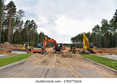 Bulldozer, Excavator and Soil compactor on road work. Earth-moving heavy equipment and Construction machinery  during road construction. Soft focus