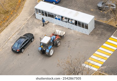 A bulldozer loader is ready to remove and load garbage near garbage containers