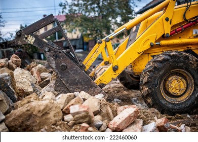 Bulldozer Loading Demolition Debris And Concrete Waste For Recycling At Construction Site