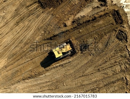 Bulldozer at mine reclamation once mining sand is completed. Land clearing, grading, pool excavation, utility trenching. Dozer during Road construction on construction site. 