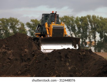 Bulldozer In Operation Moving Dirt And Clearing The Land