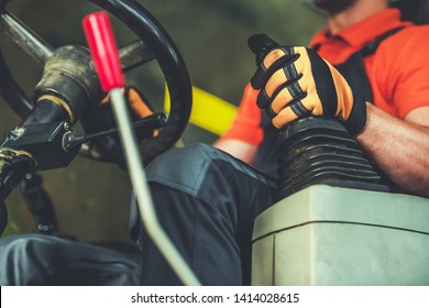 Bulldozer Operator. Caucasian Heavy Equipment Driver With Hand On A Joystick Inside Vehicle Cabin. Closeup Photo.