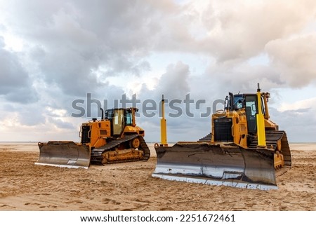 Bulldozer prepares the sea beach for the season
