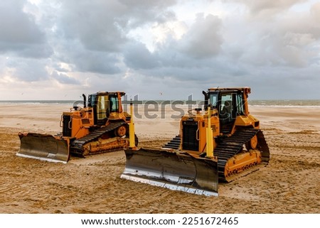 Bulldozer prepares the sea beach for the season