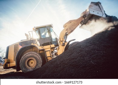 Bulldozer Putting Biomass On Pile For Composting In Industrial Facility