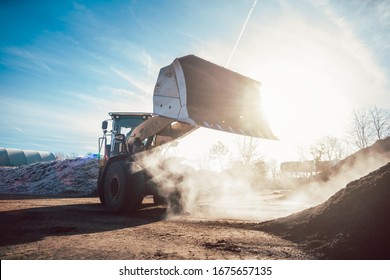 Bulldozer Putting Biomass On Pile For Composting In Industrial Facility