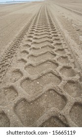 Bulldozer Tracks In The Sand On The Beach