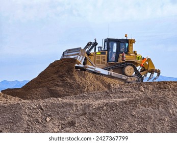 Bulldozer type construction machinery working on bulk earthworks