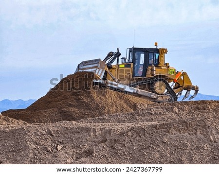 Bulldozer type construction machinery working on bulk earthworks
