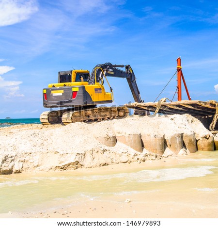 bulldozer working on a beach 