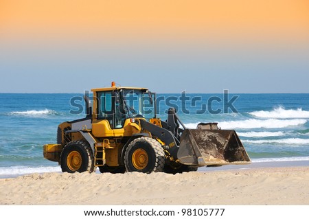 bulldozer working on a beach
