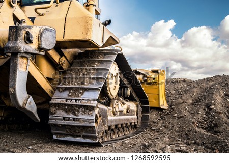 Bulldozer working on Dirt in the Construction Site