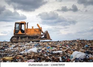 bulldozer working on landfill with birds in the sky - Powered by Shutterstock