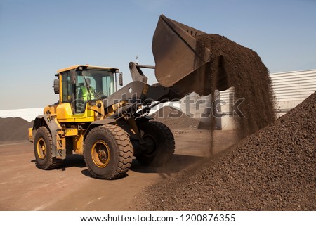 Bulldozer working on manganese in bulk wheel loader
