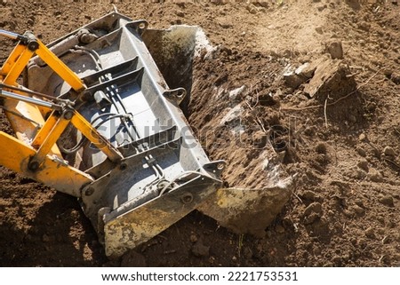 Bulldozer works on earthworks at a construction site. Bulldozer at the construction site during earthworks. Earthworks at a construction site close-up.
