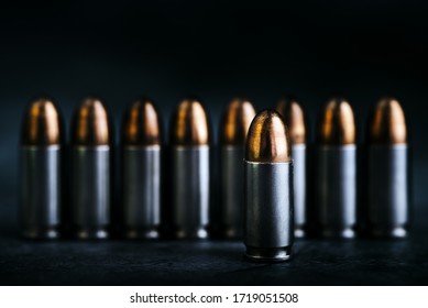 Bullet 9mm. On the dark stone table.rounds and military technology.